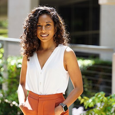 A woman in a white shirt smiling